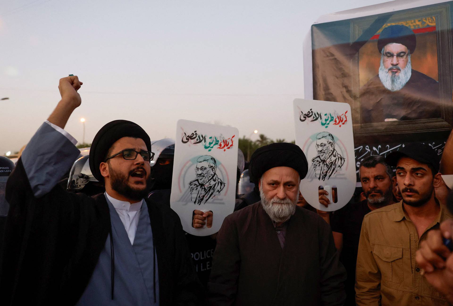 People protest following the announcement of the death of Lebanon's Hezbollah leader Sayyed Hassan Nasrallah, in Baghdad