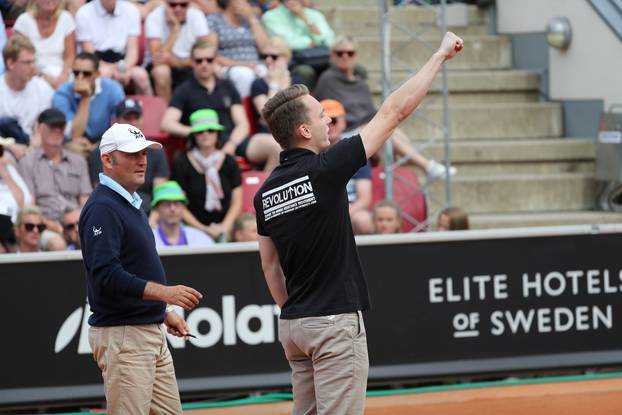 A man raises his right fist as he walks onto the court during the ATP tennis tournament Swedish Open semi-final match between Fernando Verdasco and David Ferrer, in Bastad