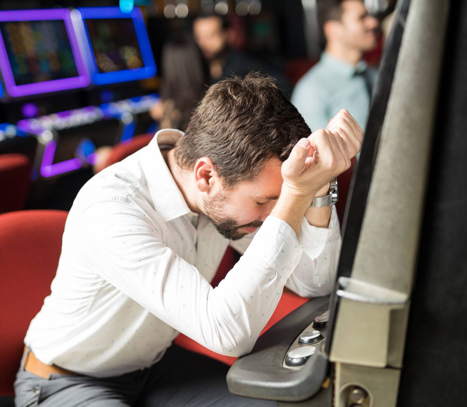 Stressed man losing money in a casino