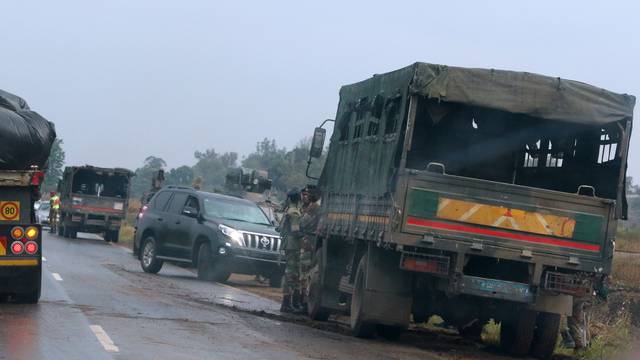 Soldiers stand beside military vehicles just outside Harare Zimbabwe