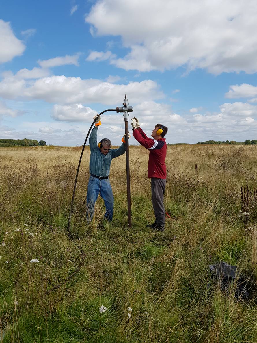 Members of the consortium which made the discovery of a wide circle of deep pits, as part of the Stonehenge Hidden Landscapes Project, conduct fieldwork in Durrington, Wiltshire