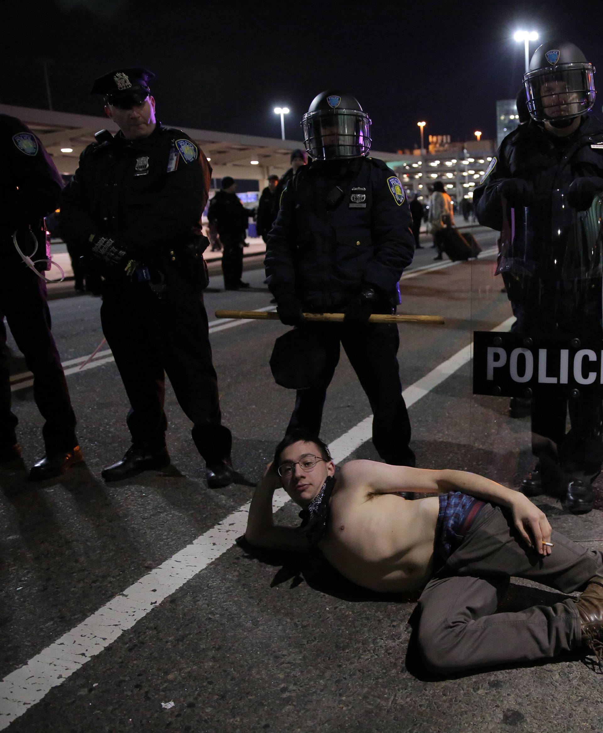 Protesters gather outside Terminal 4 at JFK airport in opposition to U.S. president Donald Trump's proposed ban on immigration in Queens, New York City, U.S.