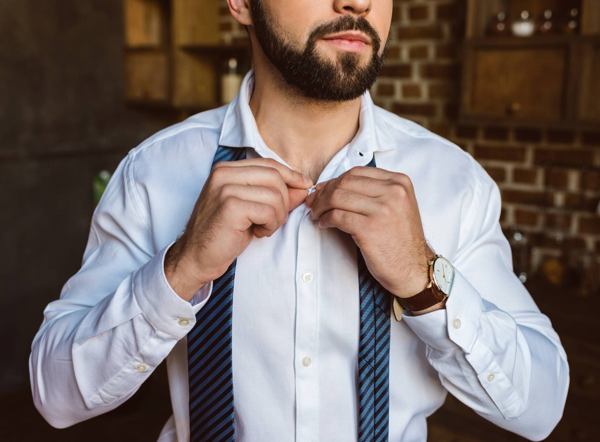 businessman fastening buttons on shirt