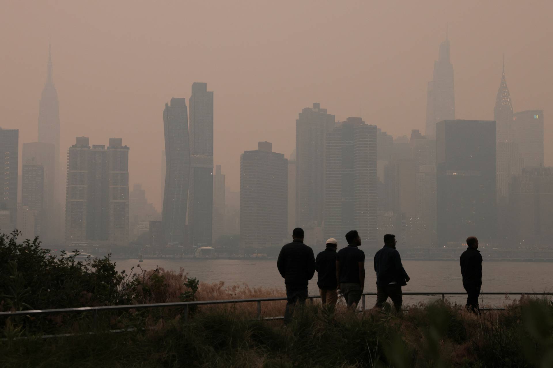 Haze and smoke caused by wildfires in Canada hang over the Manhattan skyline, in New York City