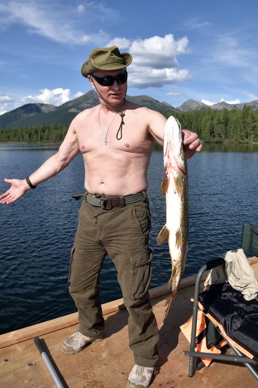 President Vladimir Putin holds a pike he caught during the hunting and fishing trip which took place on August 1-3 in the republic of Tyva in southern Siberia