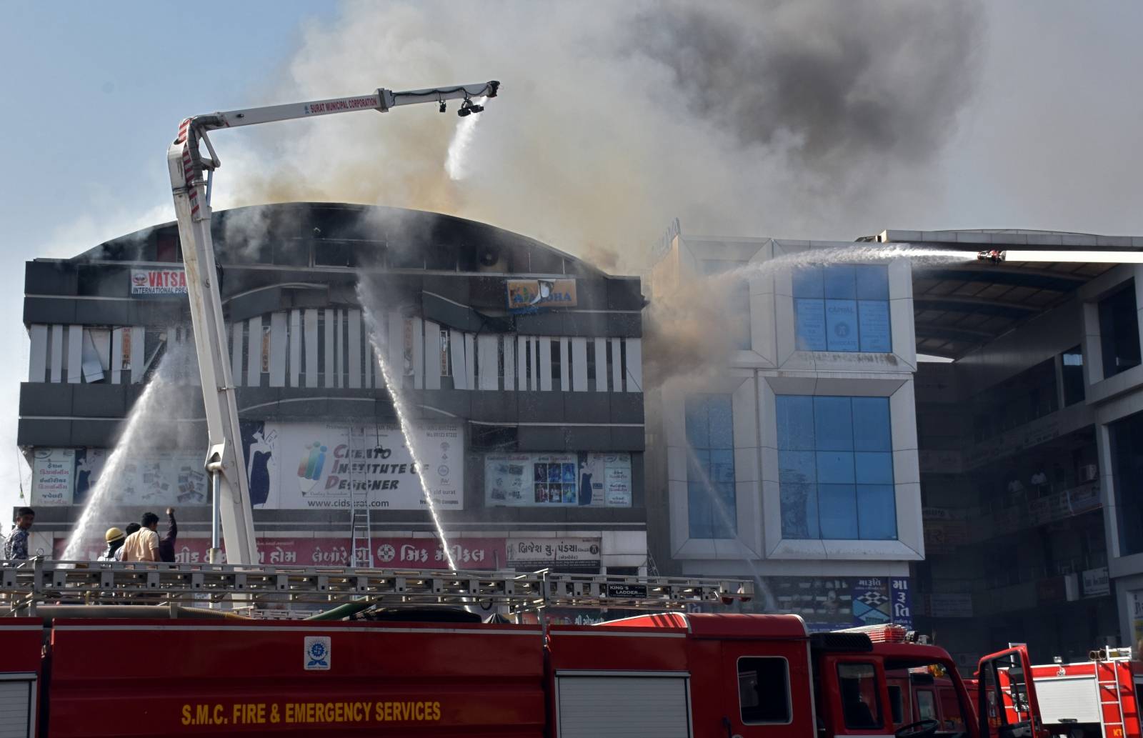 Firefighters douse a fire that broke out in a four-story commercial building in Surat