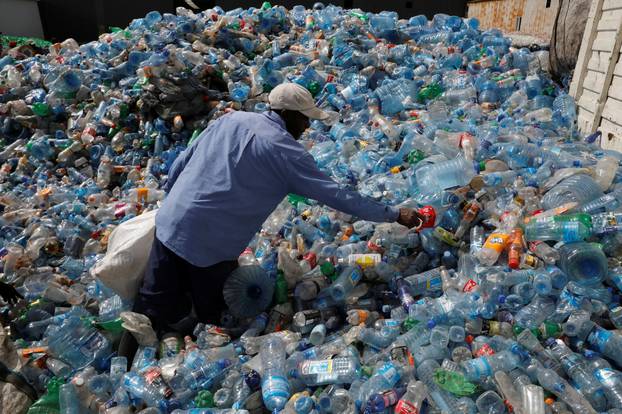 An employee sorts plastic bottles at the Weeco plastic recycling factory at the Athi River industrial zone near Nairobi