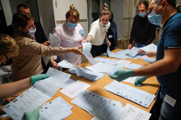 Members of a local electoral commission count ballots at a polling station after polls closed for the municipal elections in Tomsk
