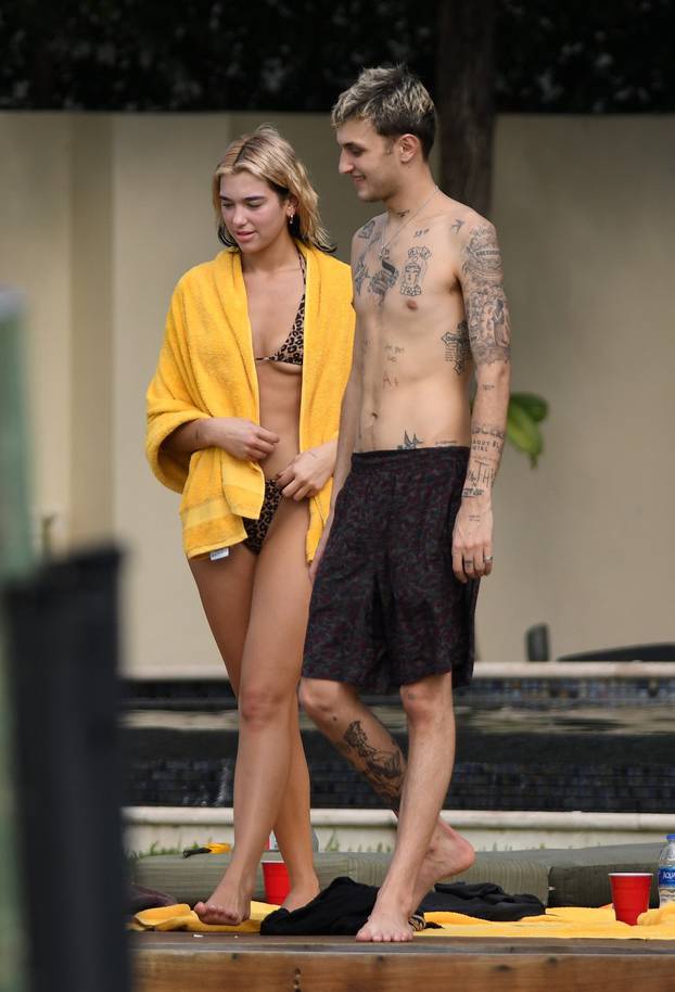 Singer Dua Lipa wears a tiny leopard print bikini as and shows plenty of PDA with boyfriend Anwar  Hadid as they relax by the pool in Miami