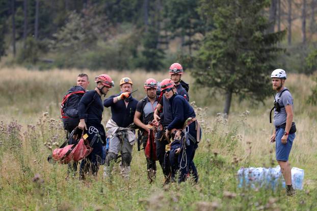 Mountain rescue team members wait for a helicopter in Zakopane