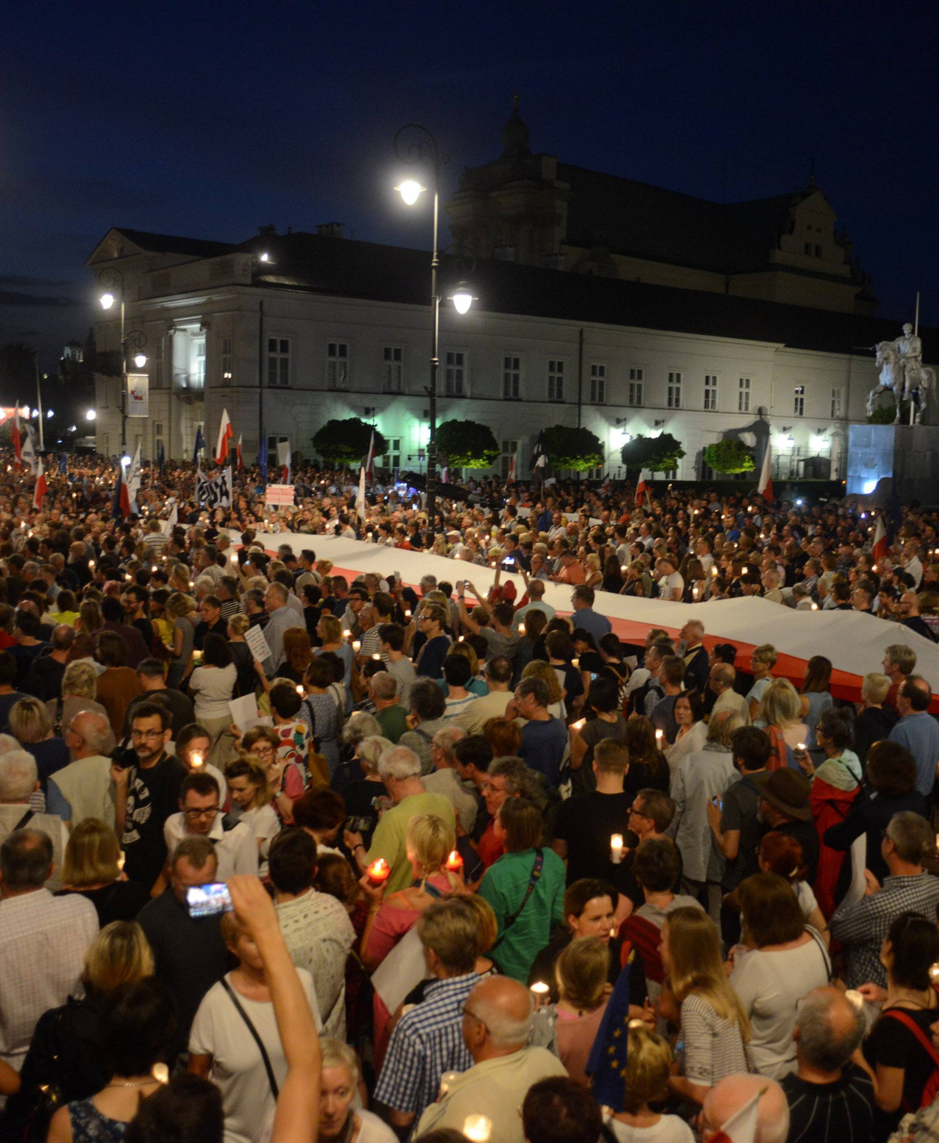 People gather during the "Chain of lights" protest against judicial overhaul in Warsaw