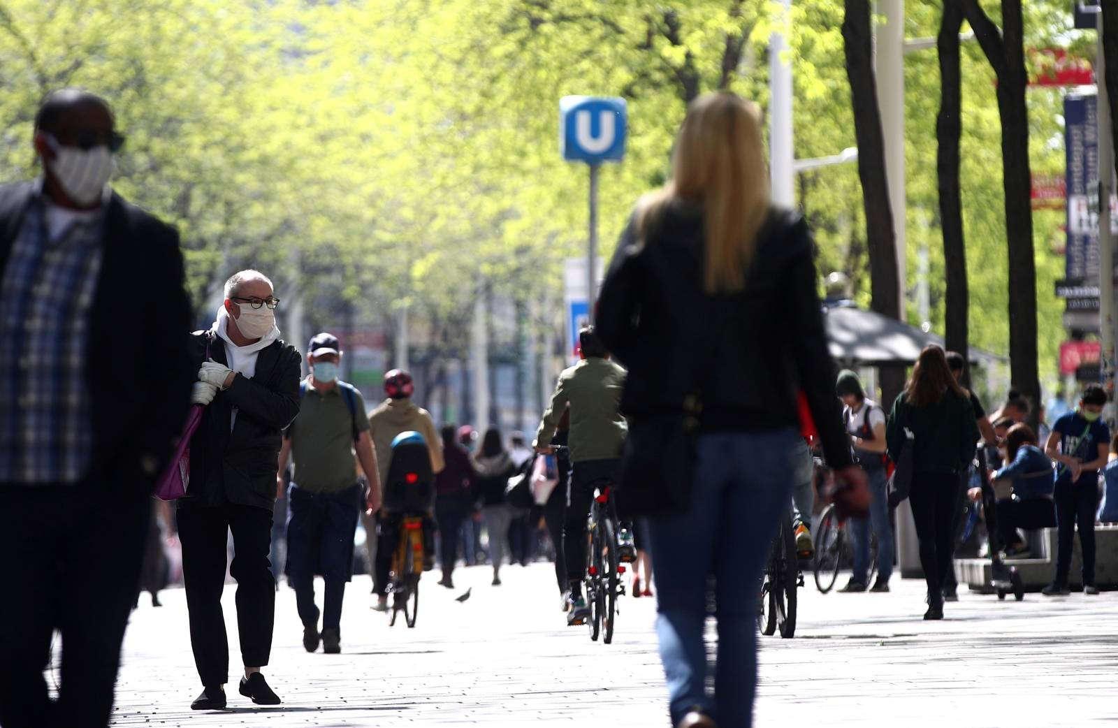 People with protective masks walk down a shopping street during the global coronavirus disease (COVID-19) outbreak in Vienna