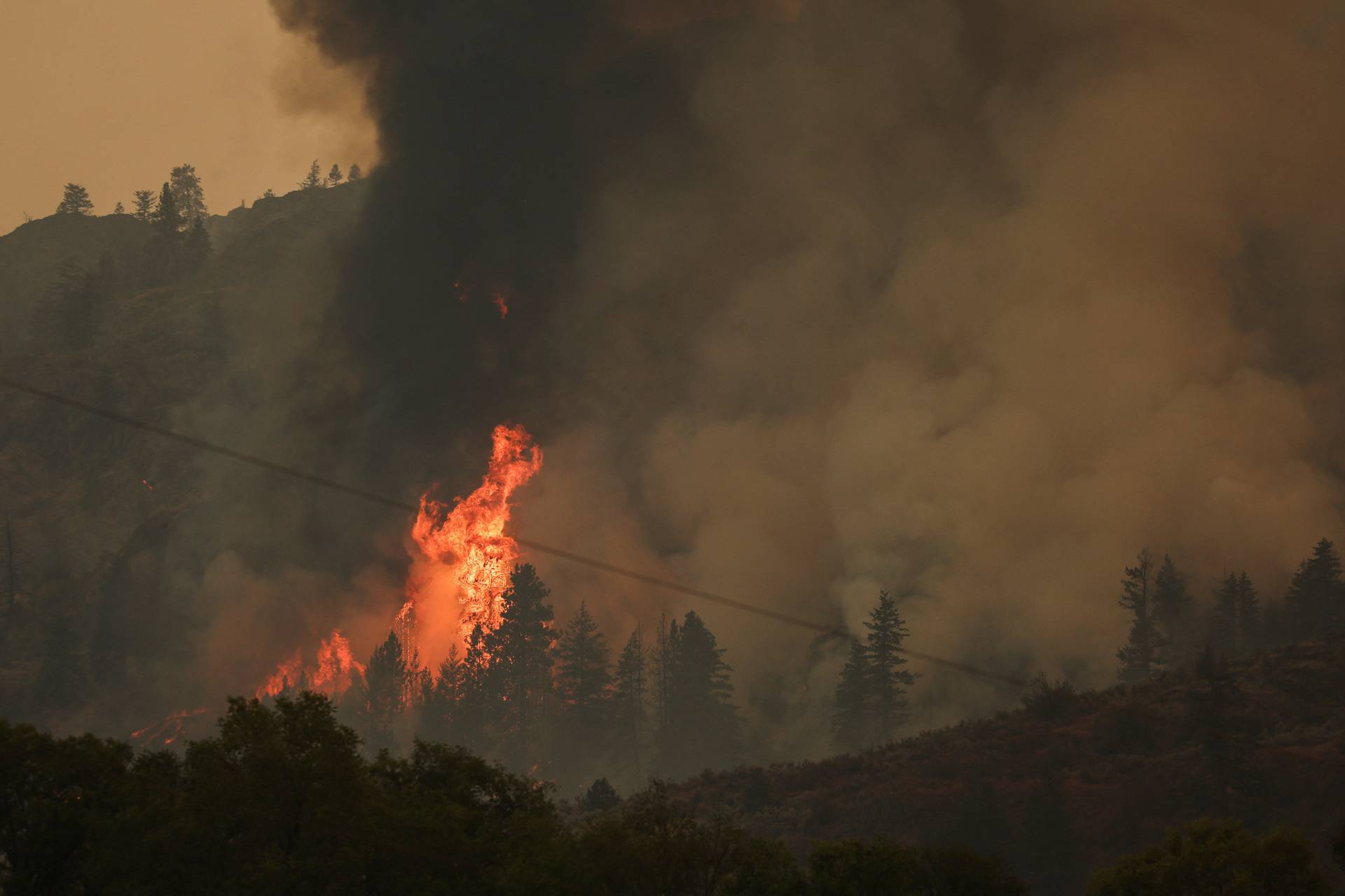 The Eagle Bluff Wildfire burns across the Canada-U.S. border from the state of Washington into Osoyoos, British Columbia