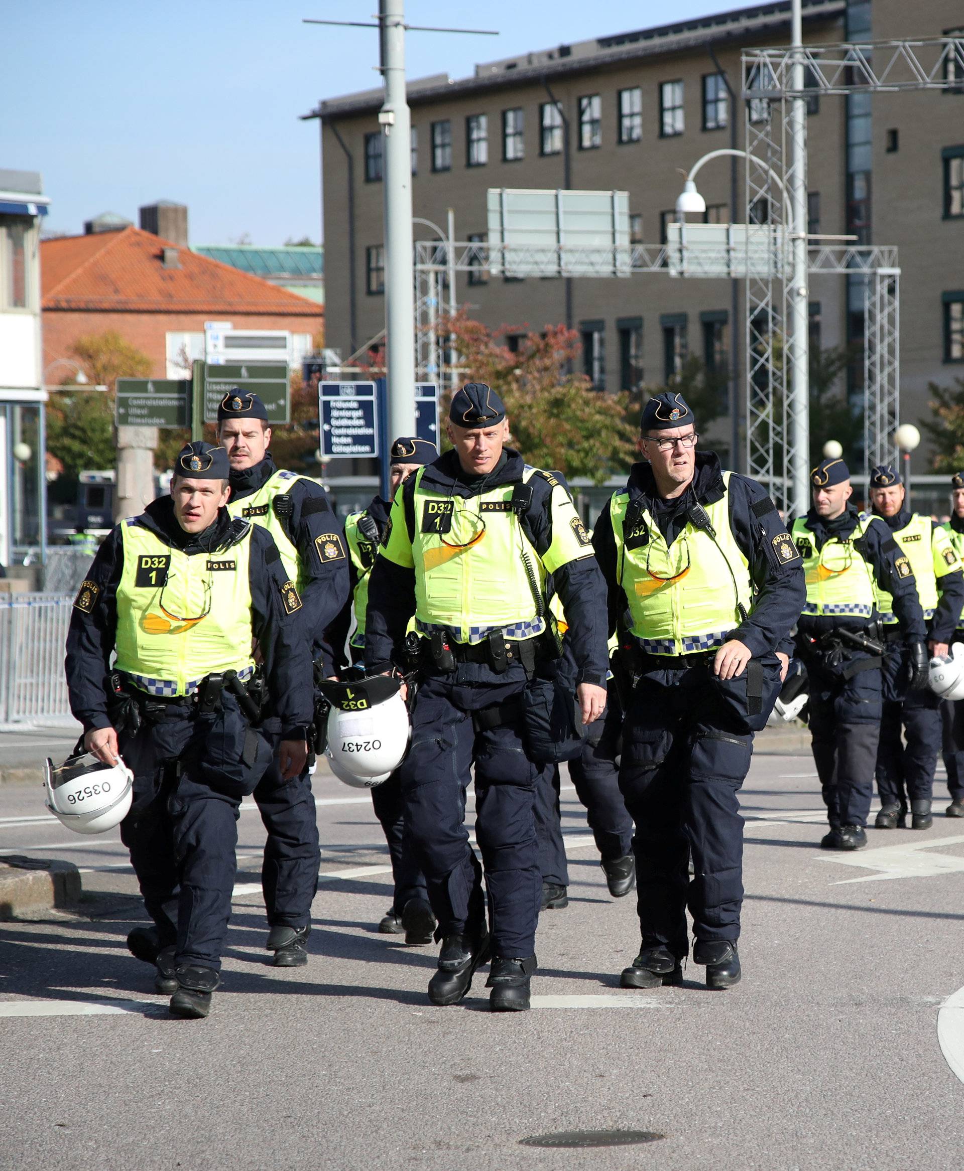 Police officers patrol along a street prior to the Nordic Resistance Movement march in central Gothenburg