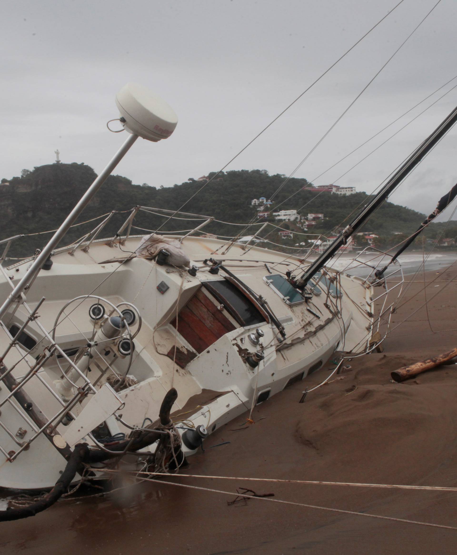 A damaged boat is pictured on the shore of  San Juan del Sur Bay