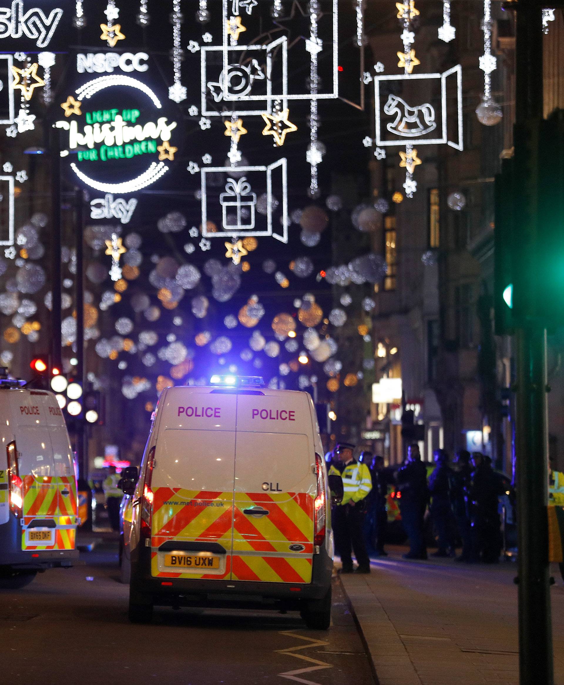 Police vehicles are parked in the Oxford Street area in central London