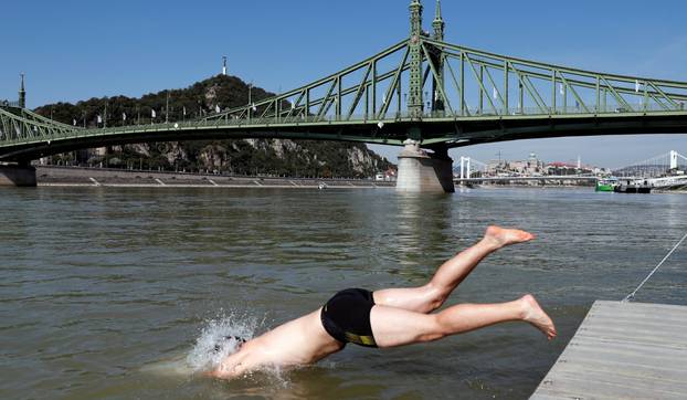 Participants swim across the Danube River during the Budapest Urban Games in Budapest