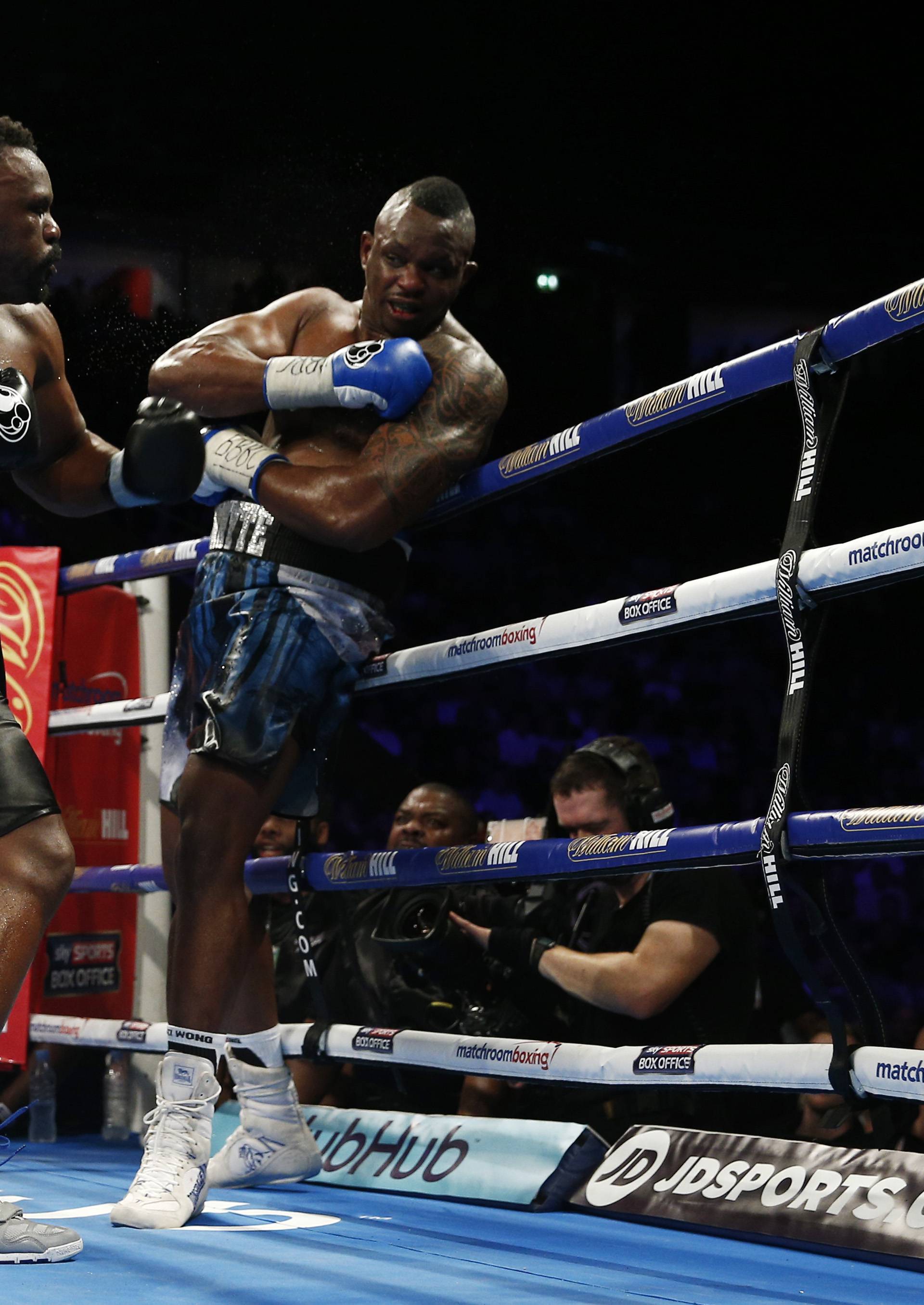 Dereck Chisora in action against Dillian Whyte (R)
