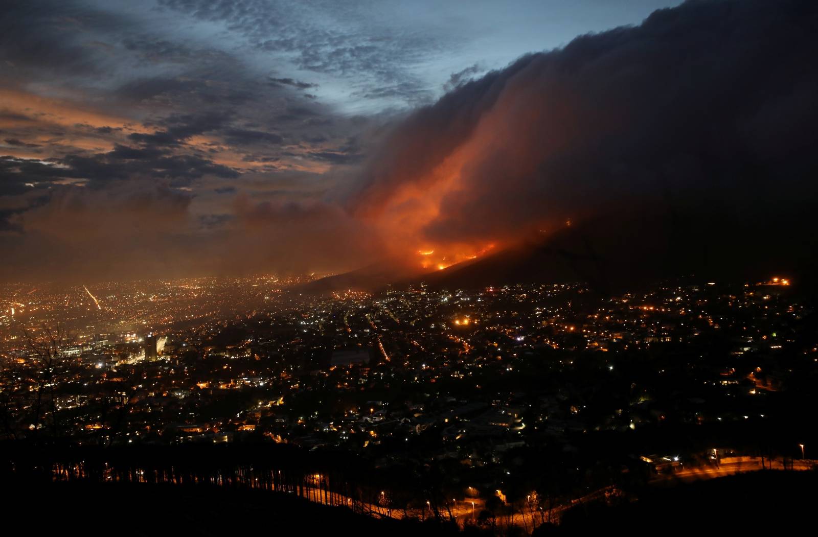 Flames are seen close to the city fanned by strong winds after  a bushfire  broke out on the slopes of Table Mountain in Cape Town