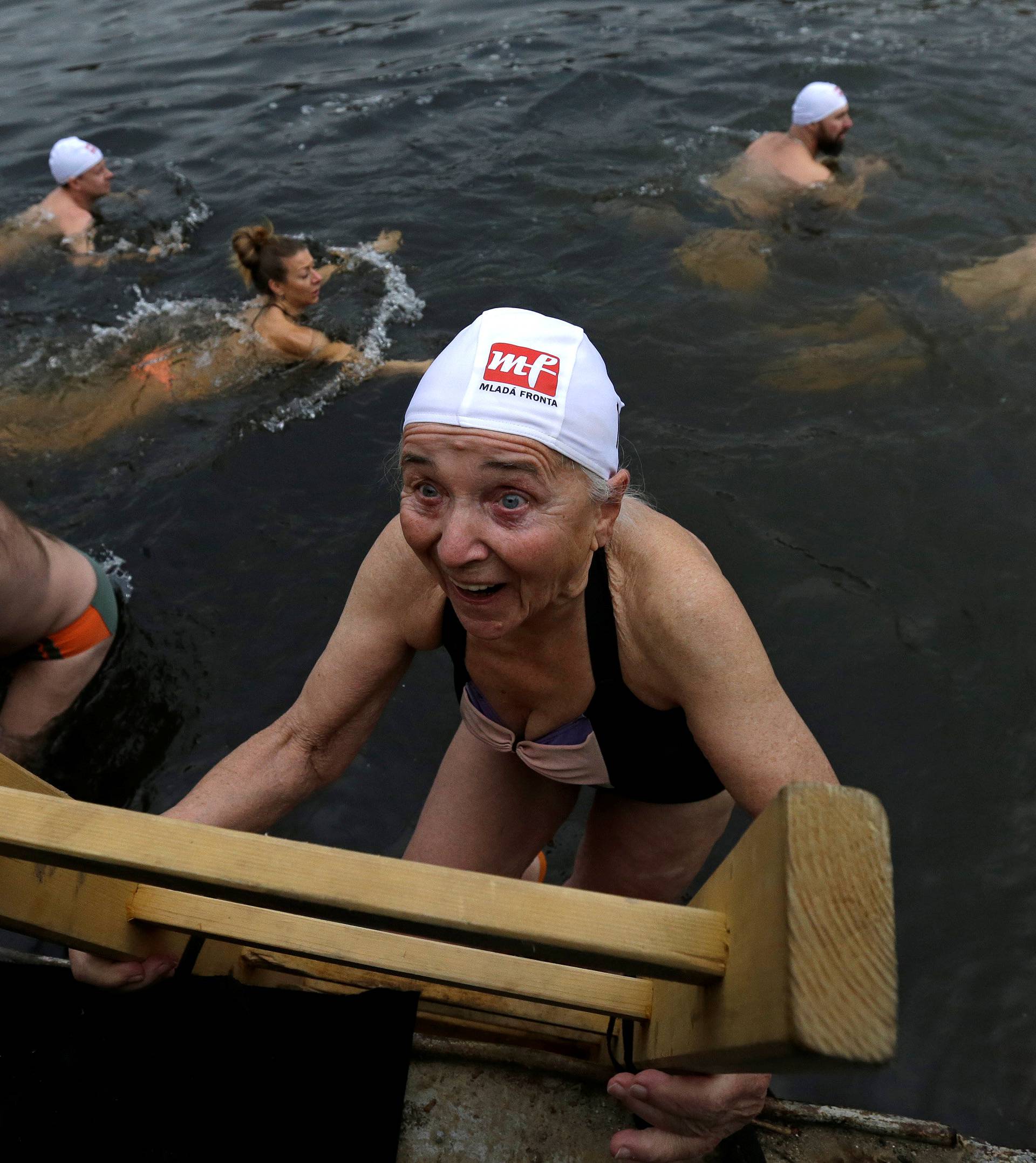 Swimmers participate in the annual Christmas winter swimming competition in the Vltava river in Prague