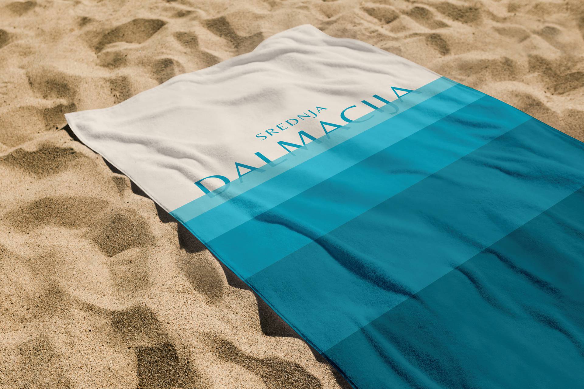 White beach towel on the sand