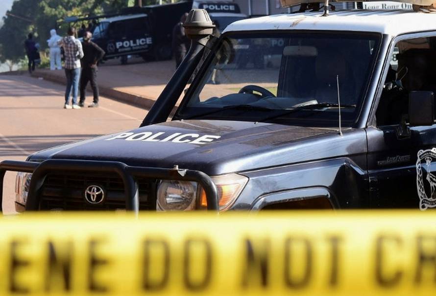 Ugandan police members secure the scene of an explosion in Komamboga, on the northern outskirts of Kampala