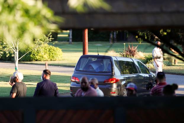 The car carrying the casket of soccer legend Diego Maradona arrives at the cemetery in Buenos Aires, Argentina