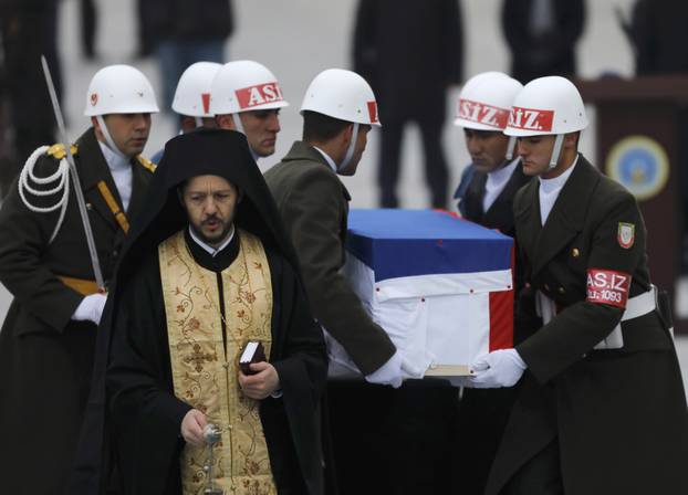 Flag-wrapped coffin of late Russian Ambassador to Turkey Karlov is carried to a plane during a ceremony at Esenboga airport in Ankara