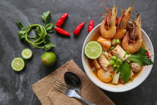 Tom yam soup originating from Thailand. Tom yum is made with shrimp, chili, lime, chicken, fish, or seafood and mushrooms.