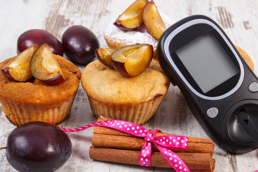 Glucometer, muffins with plums and cinnamon sticks, diabetes, delicious dessert