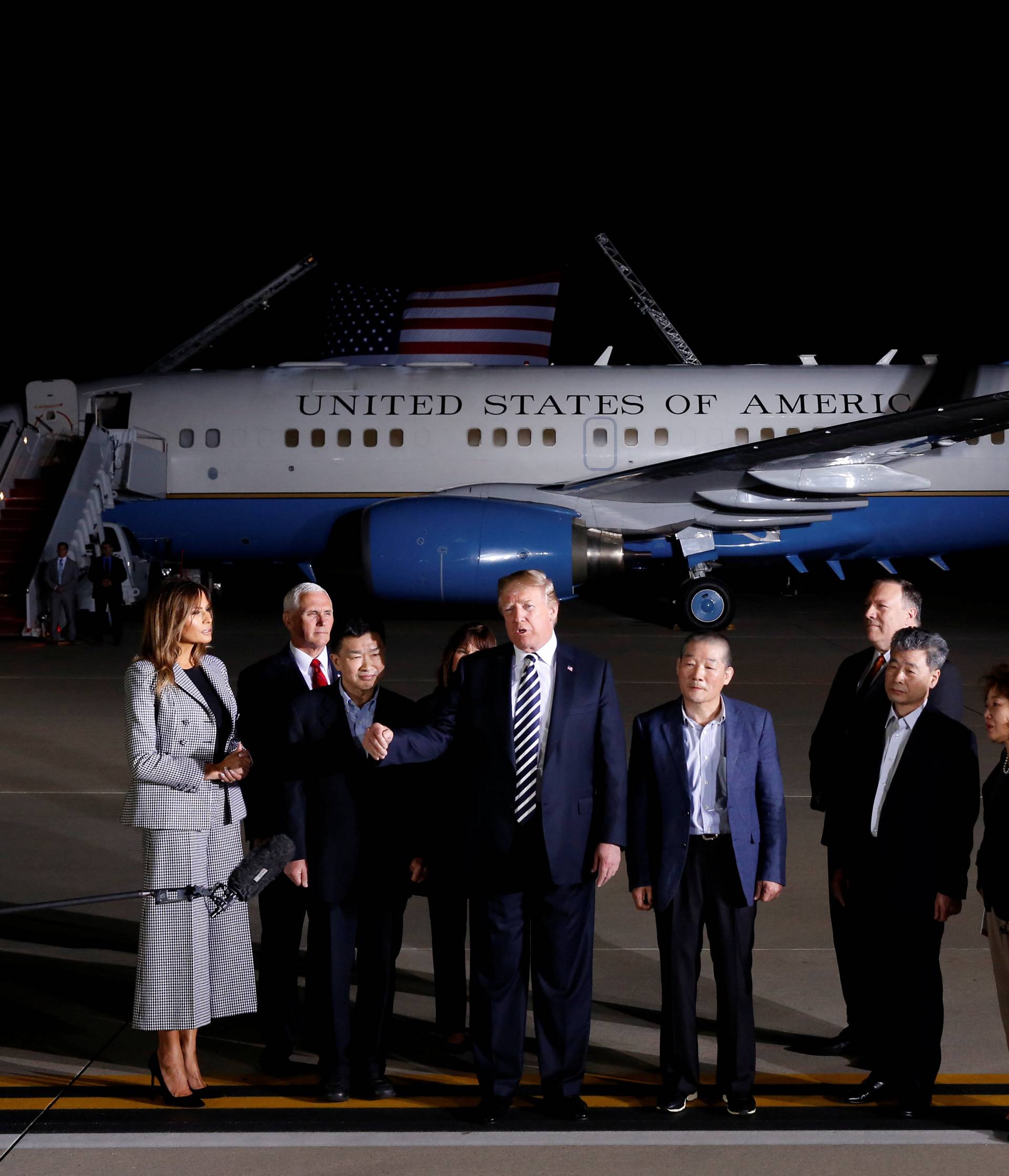 President Donald Trump talks to the media next to the three Americans formerly held hostage in North Korea, Tony Kim, Kim Hak-song and Kim Dong-chul, upon their arrival at Joint Base Andrews