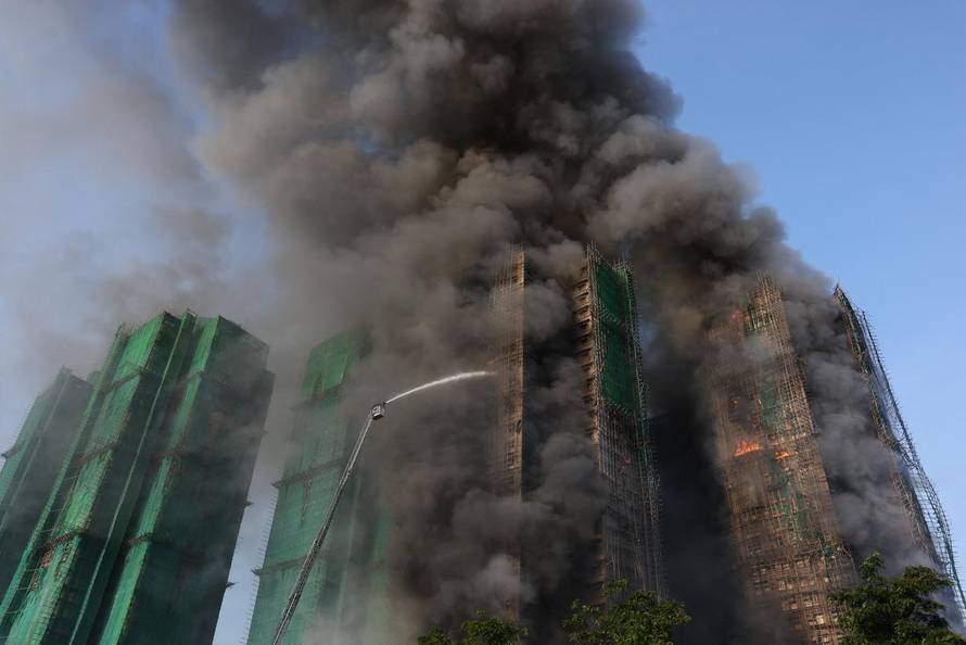 Flames engulf bamboo scaffolding across multiple buildings at Wang Fuk Court housing estate, in Tai Po