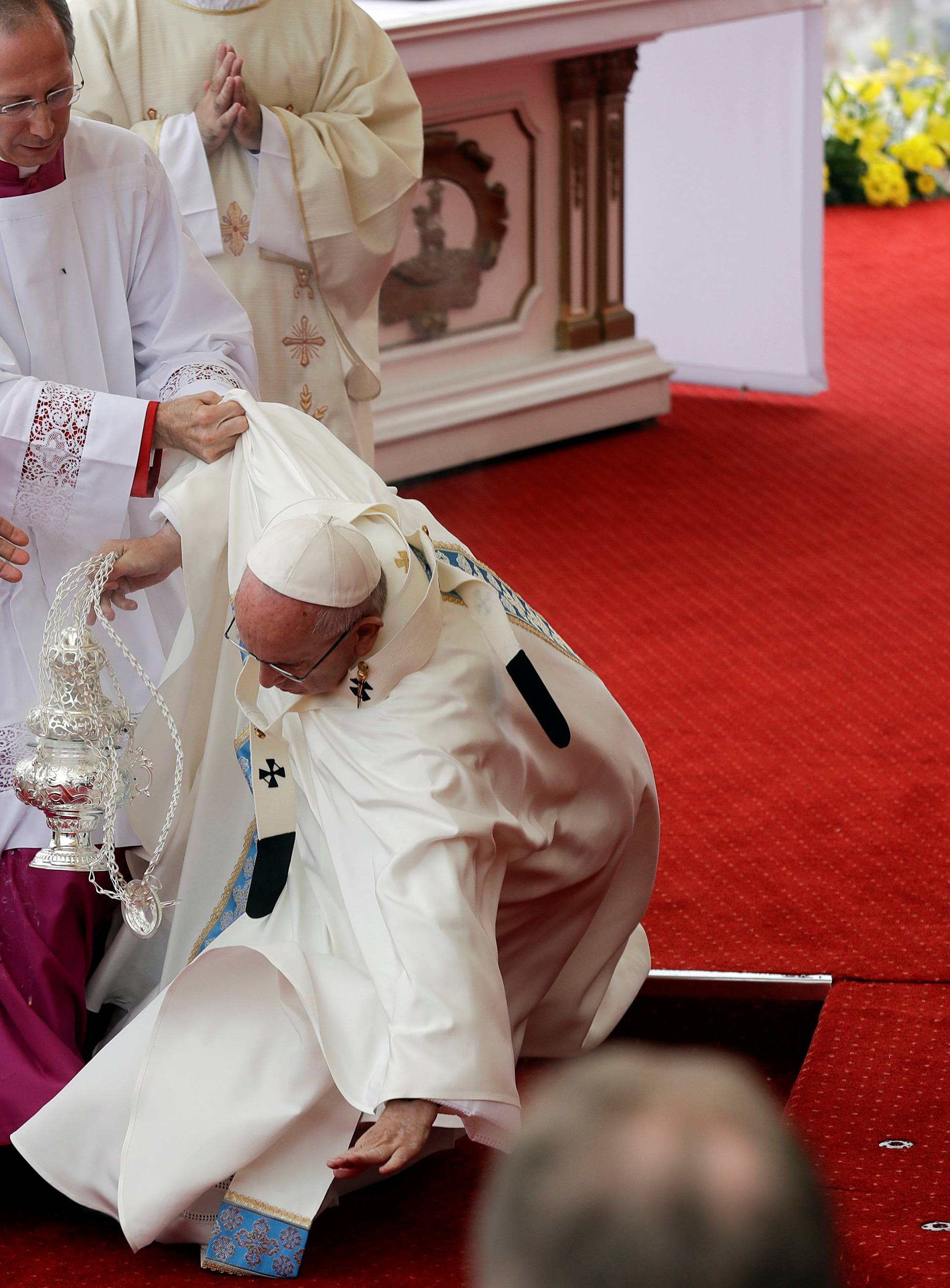 Pope Francis falls as he arrives at the Jasna Gora shrine in Czestochowa