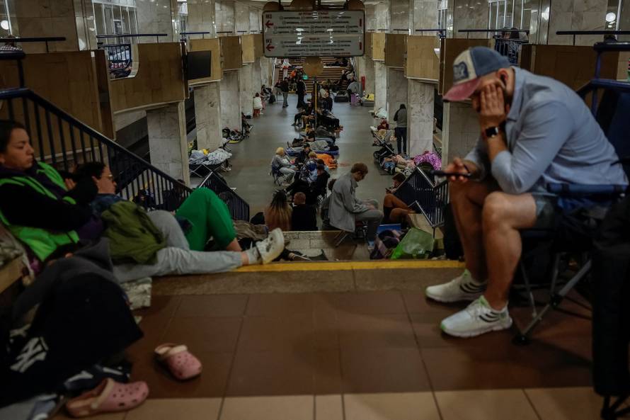People take shelter inside a metro station during a Russian missile and drone attack in Kyiv