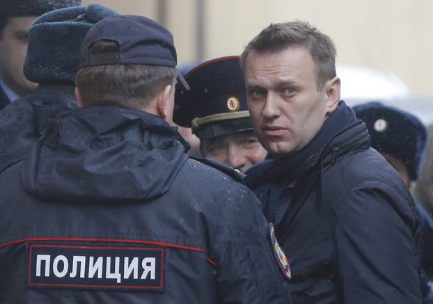 Russian opposition leader Navalny is escorted upon his arrival for hearing after being detained at protest against corruption and demanding resignation of PM Medvedev, at Tverskoi court in Moscow