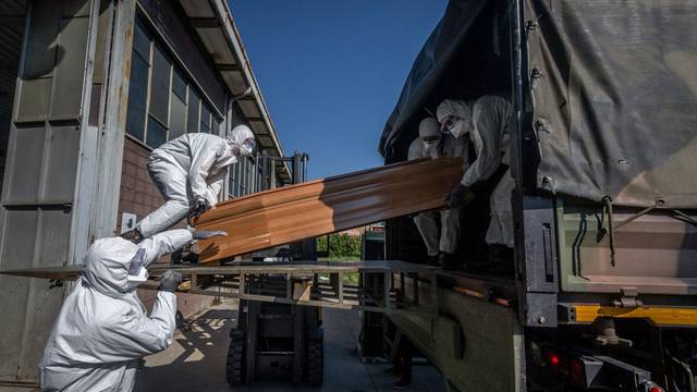 San Pietro bridge. Military and medical personnel of the Army together with the Carabinieri transport the coffins with the use of six trucks from a depot in Ponte San Pietro due to emergency COVID19 Coronavirus