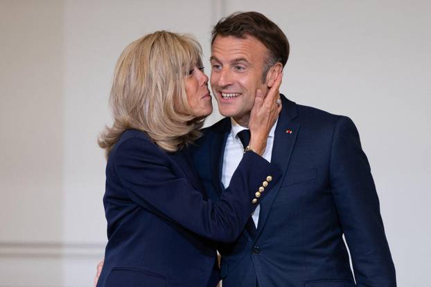 Paris, France. 29th May, 2024. French President Emmanuel Macron is welcomed by a kiss his wife, French first lady Brigitte Macron during the award ceremony No to bullying rewarding students involved in the fight againt cyberbullying at the French Elysee P