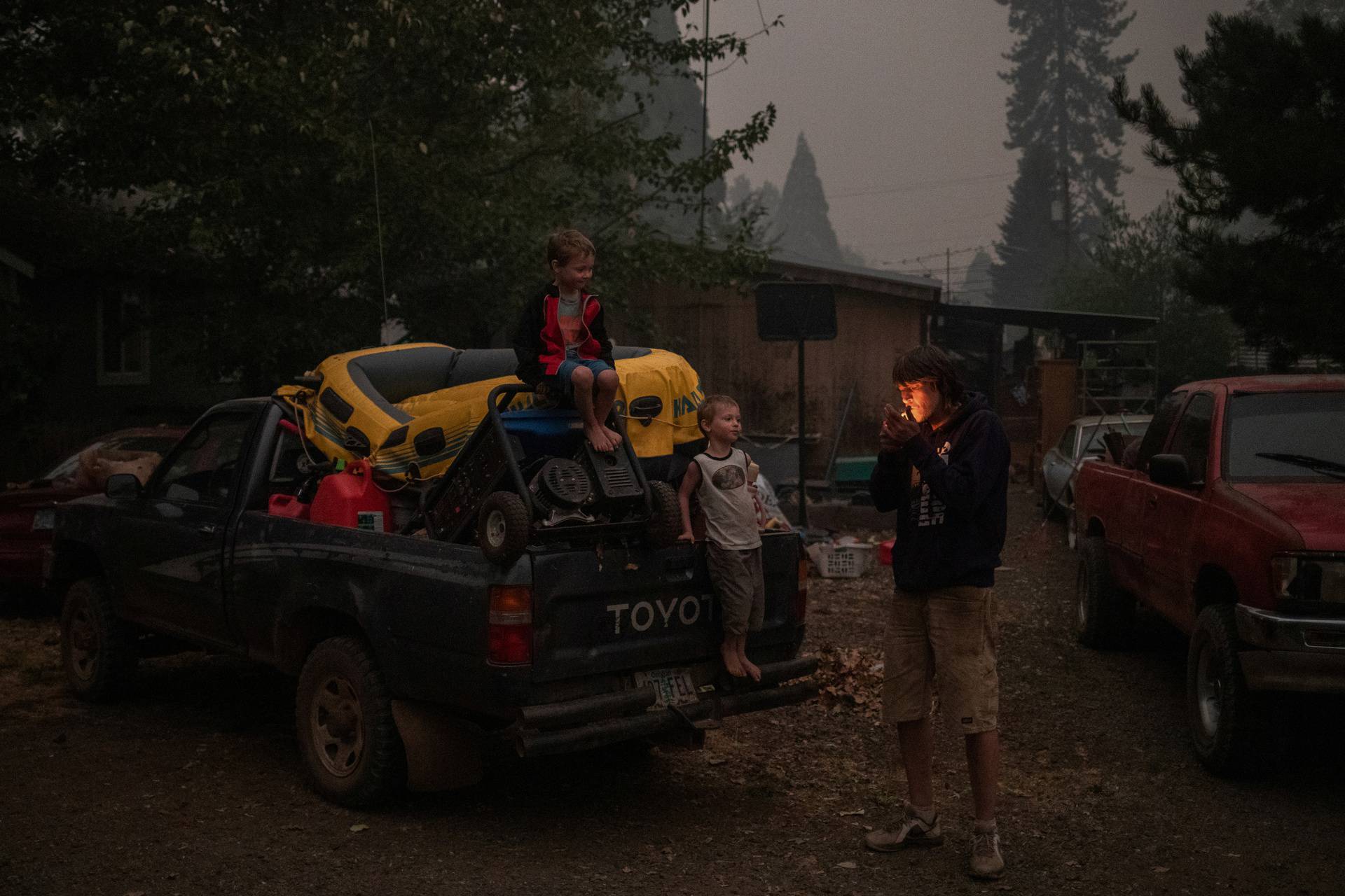 Father and twin sons prepare to evacuate their home from the Obenchain Fire in Butte Falls, Oregon