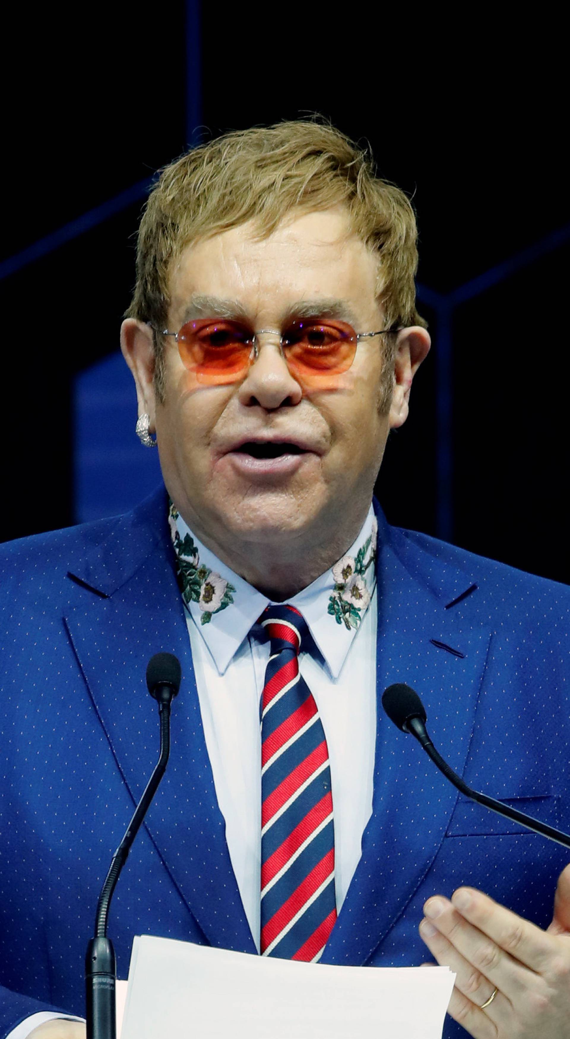 Singer Elton John speaks after receiving a Crystal Award from Hilde Schwab, Chairperson and Co-Founder, Schwab Foundation for Social Entrepreneurship, during the World Economic Forum (WEF) annual meeting in Davos