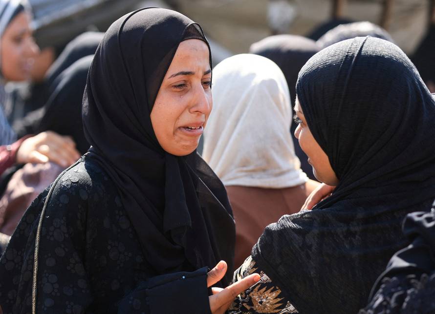 Mourners attend the funeral of Palestinians killed in overnight Israeli airstrikes, in Gaza City