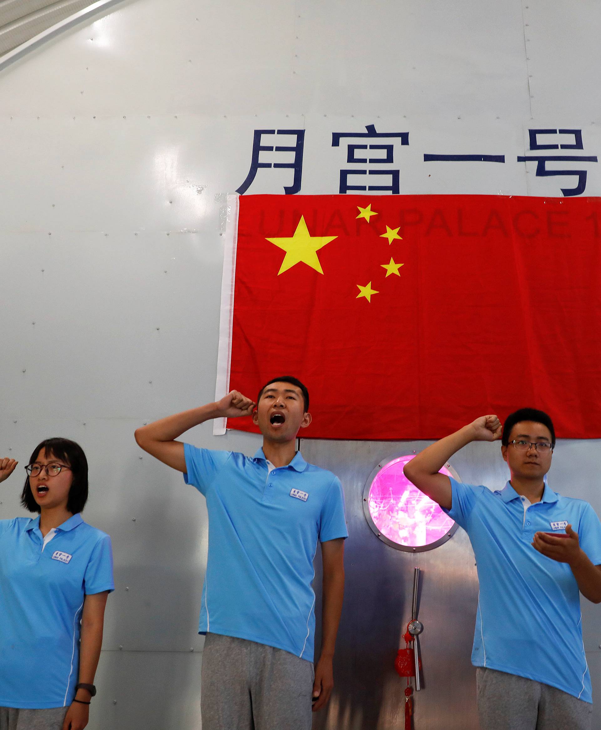 Volunteers take an oath before entering a simulated space cabin in which they will temporarily live as a part of the scientistic Lunar Palace 365 Project, at Beihang University in Beijing