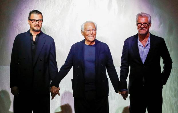 FILE PHOTO: Italian designer Giorgio Armani acknowledges applauses with Leo Dell'Orco at the end of his Spring/Summer 2025 collection during Fashion Week in Milan