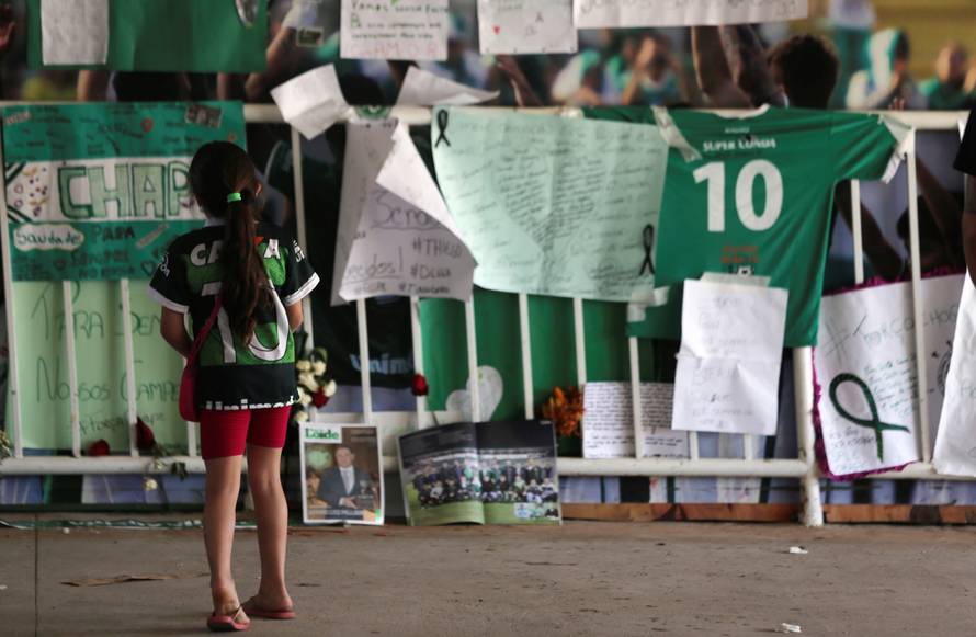 A young fan of Chapecoense soccer team pays tribute to Chapecoense's players at the Arena Conda stadium in Chapeco
