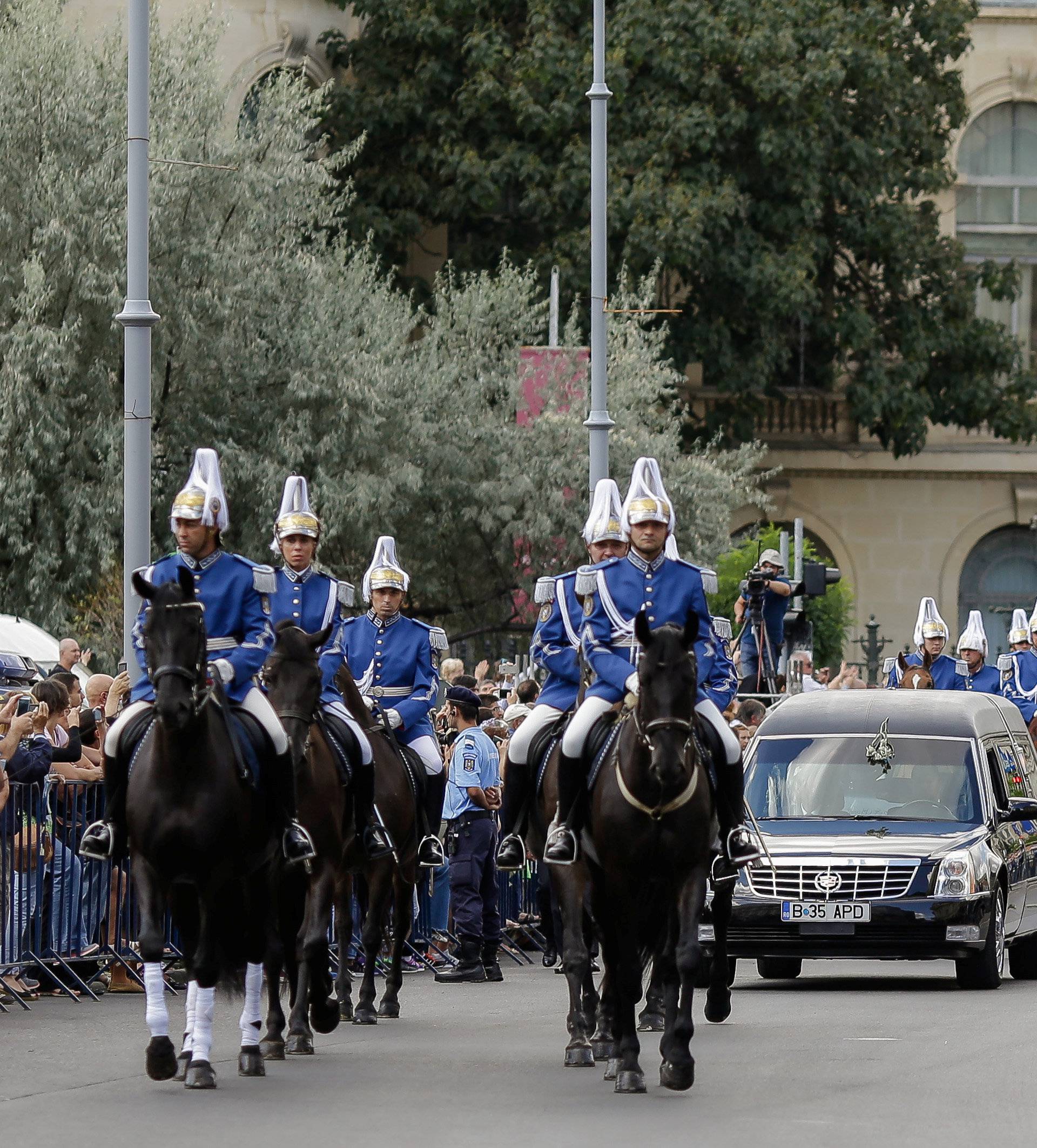 Romanian gendarmes on horseback escort a hearse transporting the coffin of the late Anne of Romania, wife of Romania's former King Michael, in downtown Bucharest