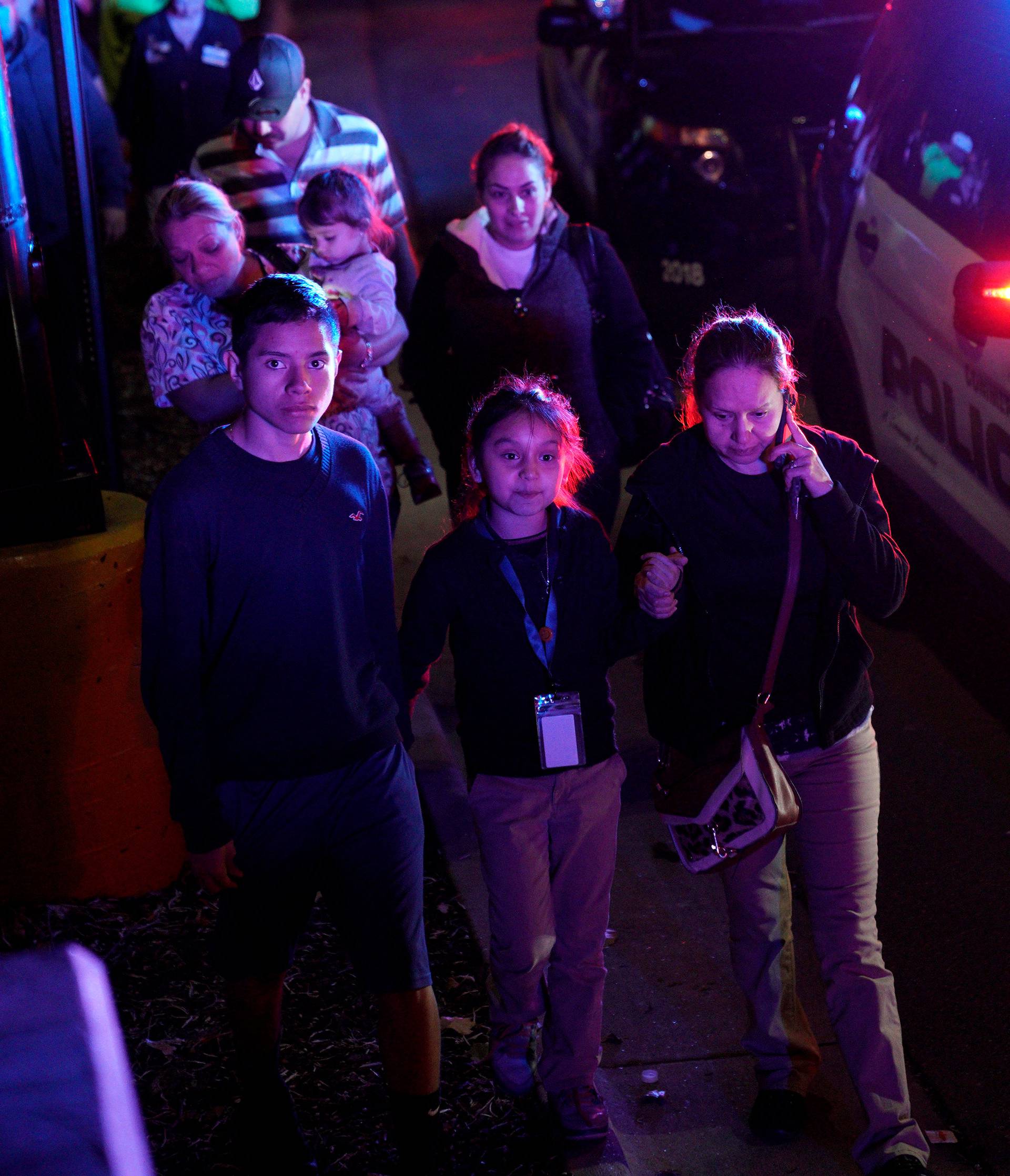 Families who were shopping during a  a shooting at a Walmart leave the scene in Thornton