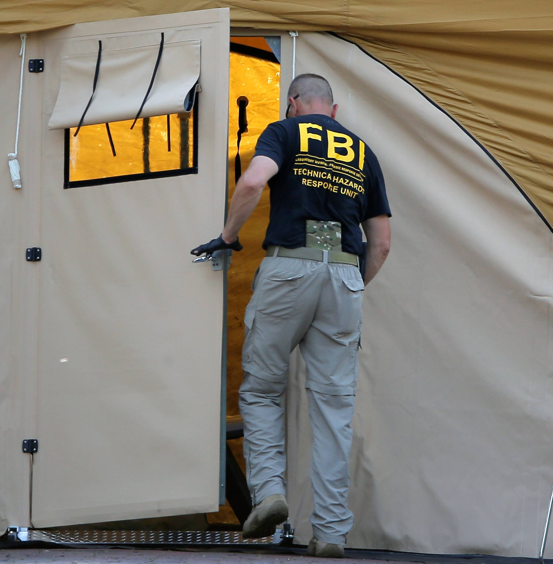 An FBI investigator works at the crime scene of a mass shooting at the Pulse gay night club in Orlando