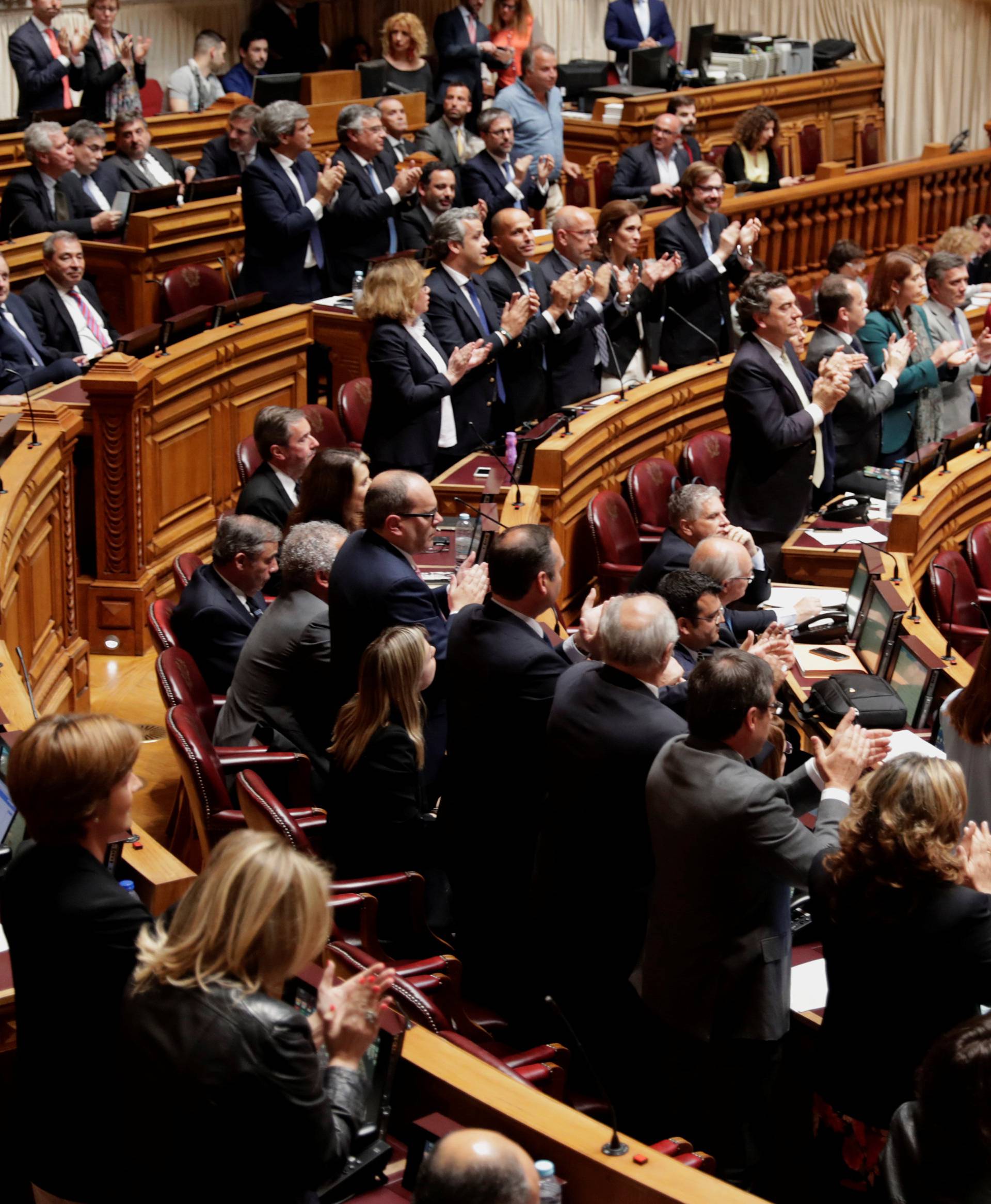 Deputies applaud after a voting on legalizing euthanasia at the parliament in Lisbon