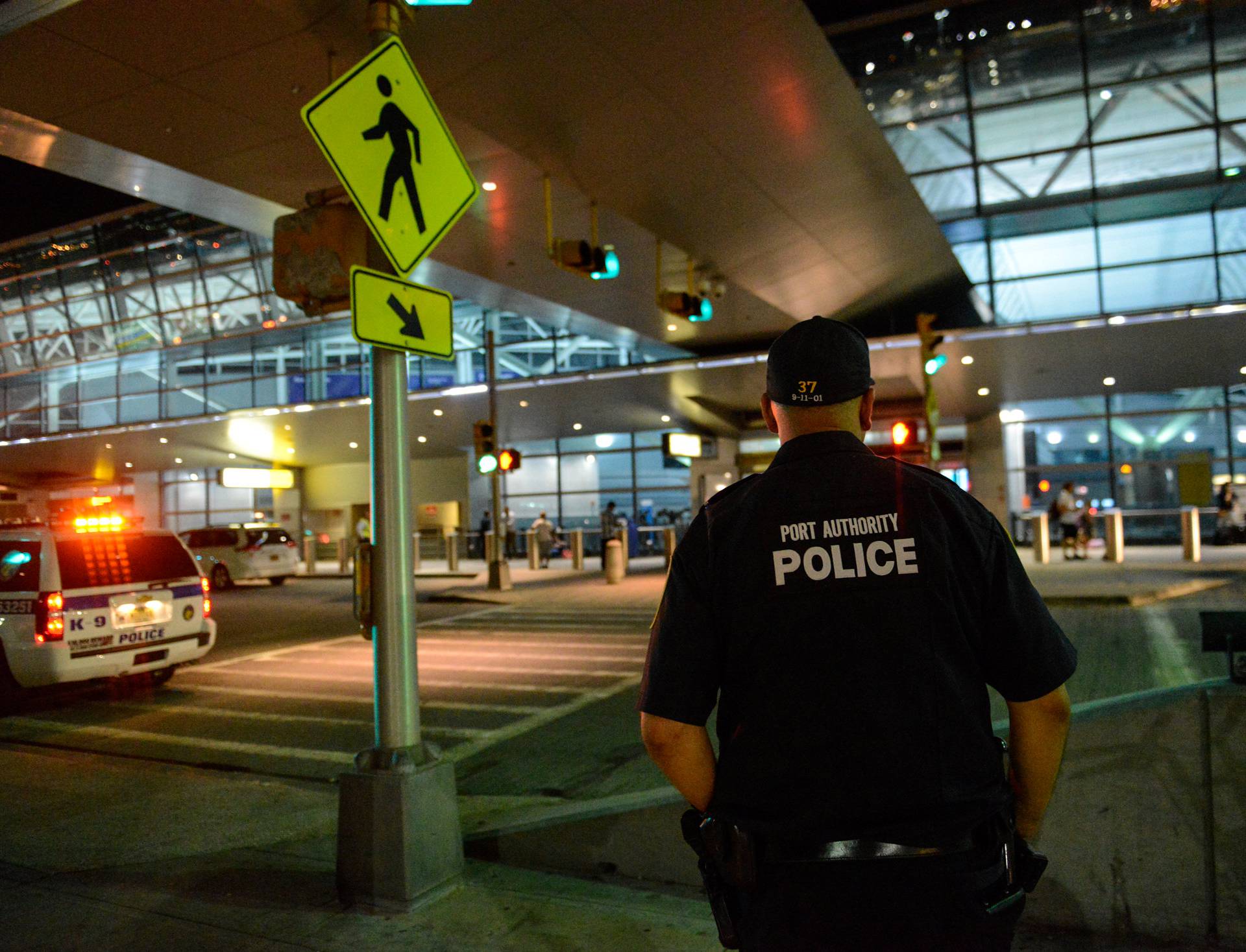 Members of the Port Authority Police Department stand guard at Terminal 8 at John F. Kennedy airport in the Queens borough of New York City