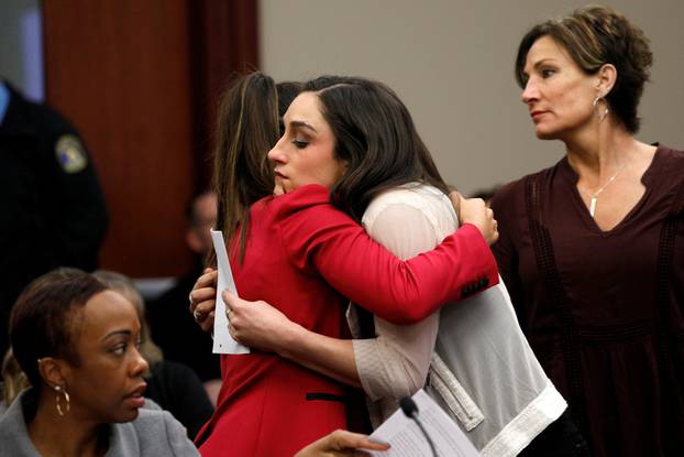 Victim and Olympic gold medalist Aly Raisman embraces former USA teammate Jordyn Wieber at the sentencing hearing for Larry Nassar, a former team USA Gymnastics doctor who pleaded guilty in November 2017 to sexual assault charges, in Lansing