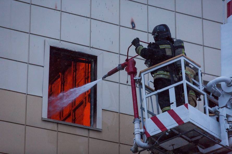 Members of the Emergency Situations Ministry work to extinguish a fire in a shopping mall in Kemerovo